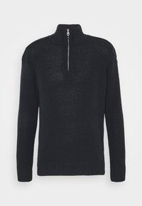 Svart stickad tröja med hög krage och kvartslång dragkedja. Det texturerade tyget har en subtil öppen väv och ribbade detaljer vid nederkant och ärmar.