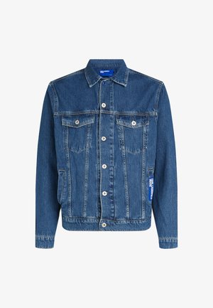 Tamsiai mėlyna džinsinė striukė su sagų užsegimu, dviem krūtinės kišenėmis ir šonine etikete. Savybė yra klasikinis apykaklė ir rankogaliai.