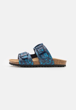 Zweifarbige Sandalen in Blau mit verstellbaren Riemen, Korkfußbett und strukturiertem schwarzem Gummiprofil. Seitenansicht gezeigt.
