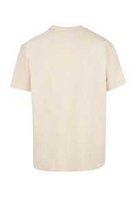 Beige katoenen t-shirt met korte mouwen, een ronde halslijn en een relaxed fit. De stof heeft een gladde, egale textuur zonder patronen.