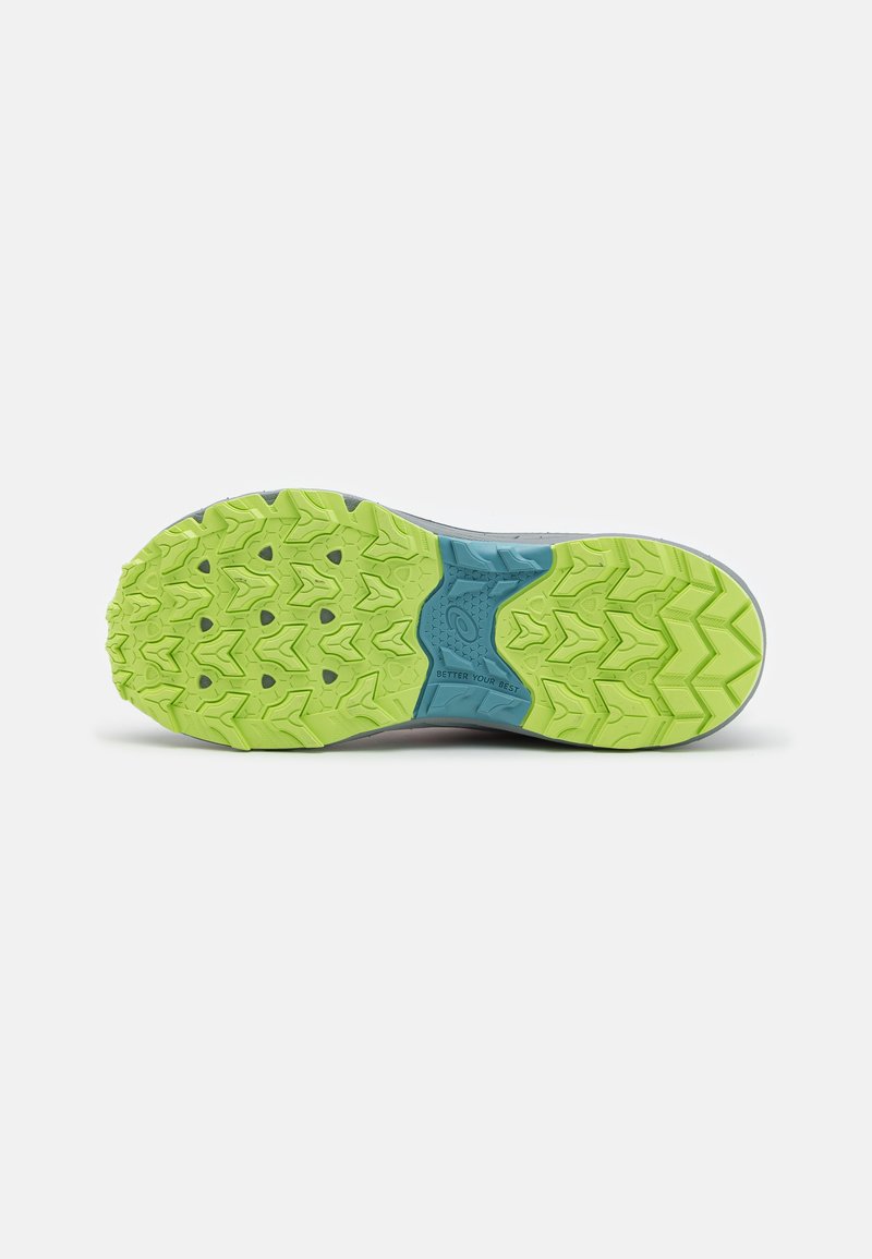 Suela de zapato de trail running con una goma verde texturizada, patrones en zigzag, una entresuela azul claro y detalles en gris.