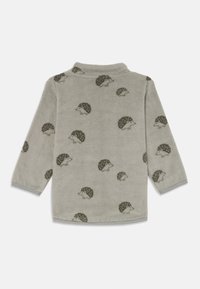 Gray fleece shirt with hedgehog patterns, long sleeves, and a soft texture. The collar is rounded with contrasting trim at the sleeves.