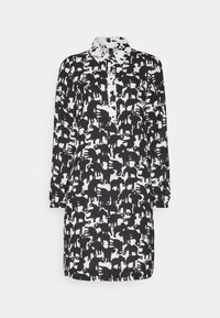 Black and white shirt dress featuring a patterned design of elephants, long sleeves, a collar, and button closure. Smooth fabric texture.