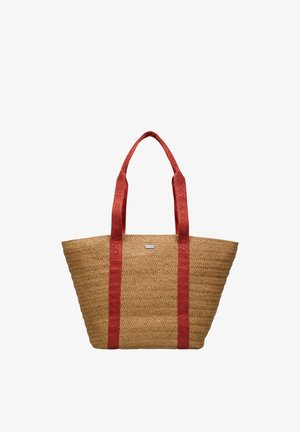 Sac fourre-tout en paille tissée avec de larges poignées en tissu rouge ornées du texte embossé « ROXY », forme trapézoïdale et petite étiquette métallique de la marque.