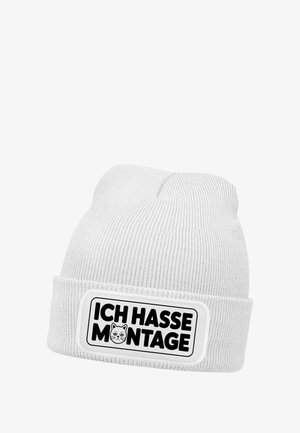 Weißer, gerippter Beanie mit einem schwarzen rechteckigen Aufnäher, auf dem der Text "ICH HASSE MONTAGE" und eine Katzen-Grafik in der Mitte zu sehen sind.