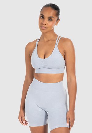 Light blue athletic set featuring a sleeveless crop top with double straps and high-waisted shorts with ribbed texture and subtle patterns.