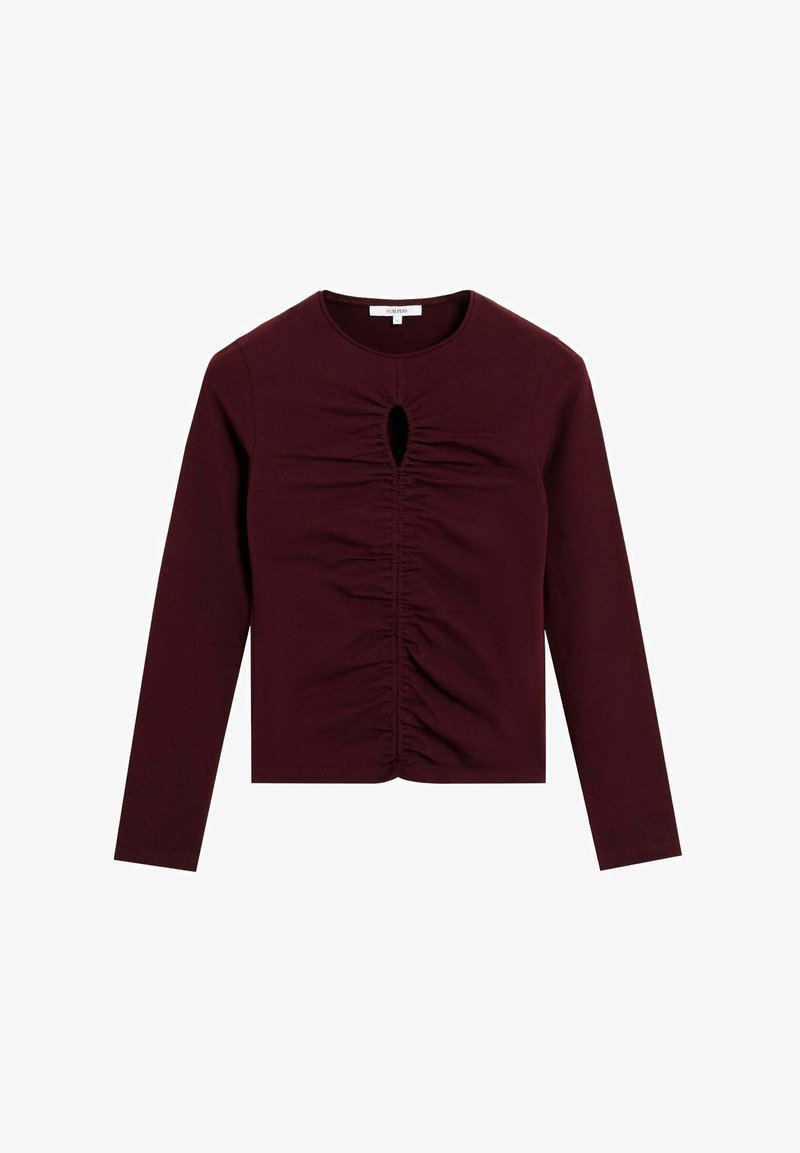 Tricou burgundy cu mânecă lungă, realizat dintr-un material elastic, având detalii de plisare frontală și o decupare în formă de cheie la gât. Design ajustat.