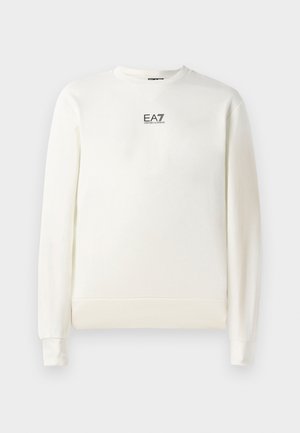 Bela terasa iz mehke tkanine s krojnim ovratnikom. Ima dolge rokave in majhen EA7 logotip na prsih. Ribujoč manšet in spodnji rob.
