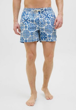 Blue patterned swim shorts made of lightweight material, featuring a drawstring waist and a mix of circular and floral motifs.
