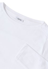 White cotton long-sleeve shirt featuring a crew neckline, CECIL label, and coordinating stitched seams. Soft texture with a relaxed fit.