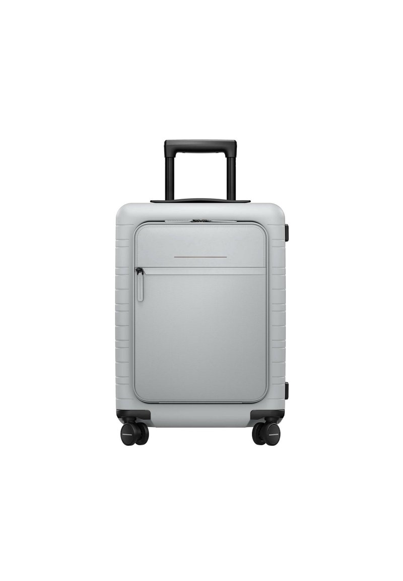 Silver hard-shell suitcase with retractable black handle, smooth texture, front zippered pocket, and four wheels for mobility.