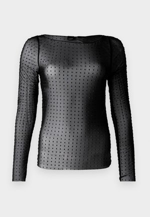 Maglietta nera a maniche lunghe realizzata in materiale trasparente, con un motivo a pois e piccoli borchie. Collo rotondo e design aderente.