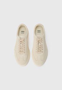 Pair of beige suede sneakers with laces, branded "BOSS" and "Ortholite" insoles, viewed from above on a white background.