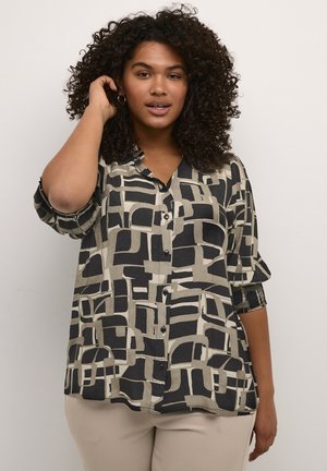 Hemd mit Knopfleiste, das ein geometrisches Muster in Schwarz und Beige zeigt. Lange Ärmel mit hochgekrempelten Manschetten und einem lockeren Schnitt. Glatte Stofftextur.