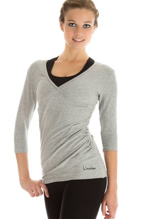 Gray fitted long-sleeve top with a wrap design and three-quarter sleeves, featuring a black inner layer and subtle gathering detail at the waist.
