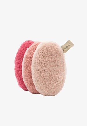 Set of three oval-shaped, soft fabric cleansing pads in shades of pink and peach. Textured surface; features a small branded label.