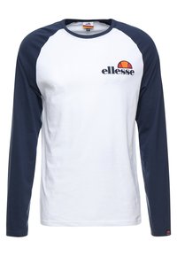 Bílá košile s dlouhým rukávem a námořnickými raglánovými rukávy. Má kulatý výstřih a malou značku na hrudi. Vyrobena z bavlněné tkaniny.