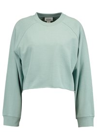 Miętowo-zielona krótka bluza z raglanowymi rękawami, ściągaczami na mankietach i teksturowanym wykończeniem tkaniny. Etykieta wewnątrz pokazuje nazwę marki "MONKL."