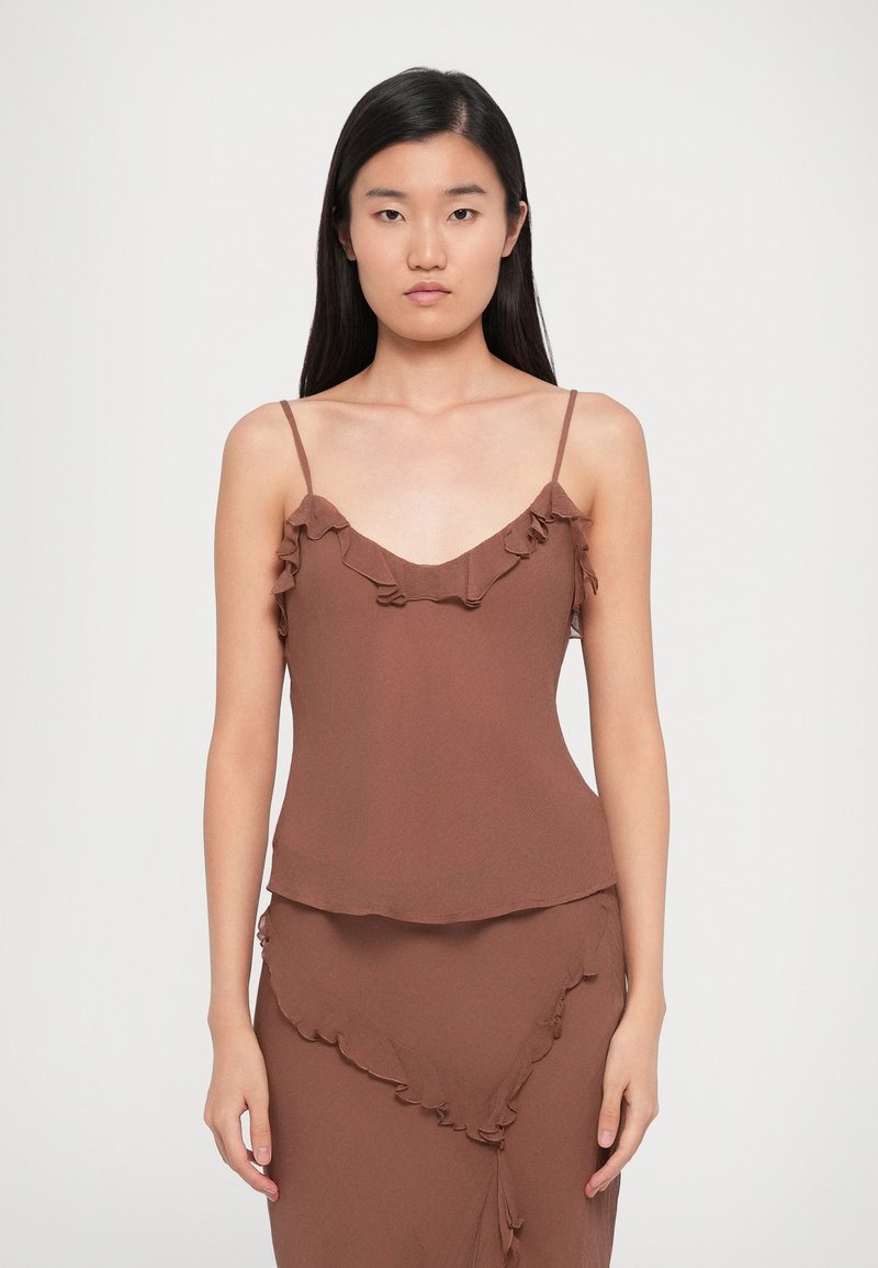 Brown, lightweight camisole with thin straps, featuring a ruffled neckline and a flowing silhouette. Smooth texture, simple design.