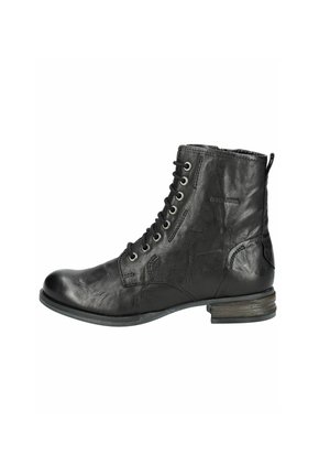 Bottine en cuir noir à lacets, à bout rond et à talon bas. Présente des détails de couture et une languette à l'arrière.
