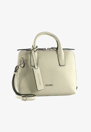 Petit sac à main en cuir crème avec doubles poignées, bandoulière amovible, fermeture éclair, et une étiquette de marque indiquant "Picard".