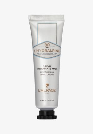 Feuchtigkeitsspendende Handcreme in einer glänzenden silbernen Tube mit blauen Akzenten. Der Text enthält "L'Hydralpine" und "30 ML - 1.0 FL.OZ." auf der Vorderseite.