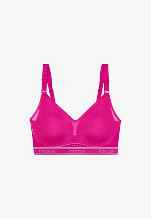 Brassière de sport sans fil rose vif avec bretelles réglables et bande élastique portant l'inscription "triaction" en bas, conçue pour le soutien et le confort.