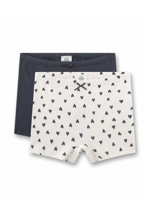 Due paia di pantaloncini per bambini, uno blu scuro tinta unita e uno bianco con motivi di cuori neri, ciascuno con un piccolo fiocco al centro della vita.