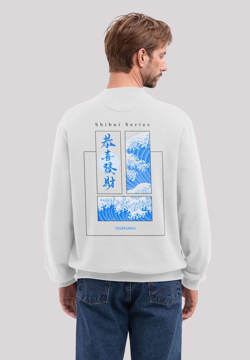 White sweatshirt featuring blue wave graphic with Japanese text on the back. Loose fit, soft texture, ribbed cuffs, and hem.