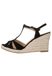 Sandal con zeppa nera in suede, design con tracolla a T, punta aperta e tacco a zeppa in iuta intrecciata. Presenta una cinghia alla caviglia regolabile e una suola testurizzata.