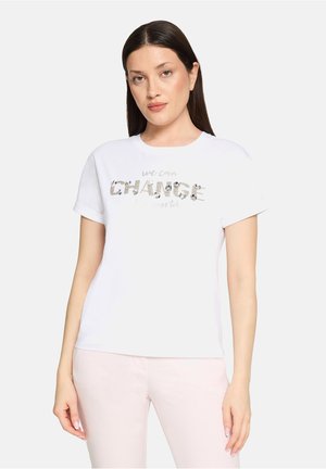 White cotton t-shirt featuring a silver sequined "CHANGE" graphic in a bold font, with rolled short sleeves and a relaxed fit.