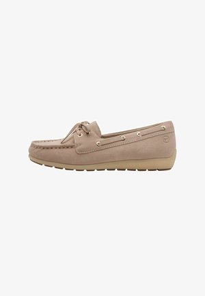 Suede moccasin-style shoe in light beige, with stitching details, lace accents, and gold-tone eyelets, featuring a rubber sole.