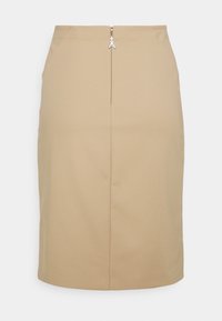 Fustă creion bej cu un design elegant, având un închidere cu fermoar la spate și cusături subtile pentru o siluetă ajustată. Textură de țesătură netedă.