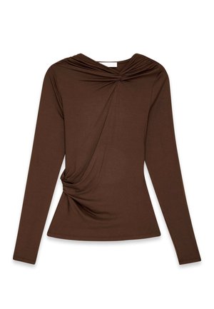 Brown long-sleeve top with twisted knot detail at the neckline and side, fitted shape, plain texture on a white background.