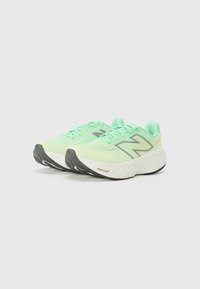 Green running shoes with mesh upper, prominent gray logo, cushioned white midsole, and textured black outsole for traction.