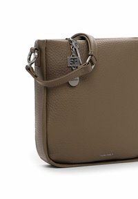Brown leather crossbody bag with textured surface, top handle, silver hardware, and logo detail. Compact rectangular design.