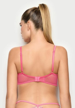 Reggiseno rosa in pizzo con spalline regolabili, motivo a pois e chiusura a gancetto sul retro, caratterizzato da tessuto trasparente per una texture aggiuntiva.