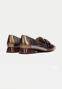 Bronzen leren balletflats met een lage gestapelde hak, voorzien van een decoratieve voorband en tekstuurlijke rugpanelen. Glad afwerking, elegante uitstraling.