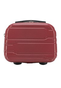 La valigia rigida rossa presenta un design perforato, forma rettangolare, manico nero e quattro piccole ruote per la mobilità.