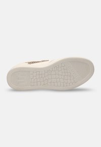Sole of a sneaker featuring a textured rubber bottom, off-white color, and a subtle logo design. Rounded edges and patterned traction.