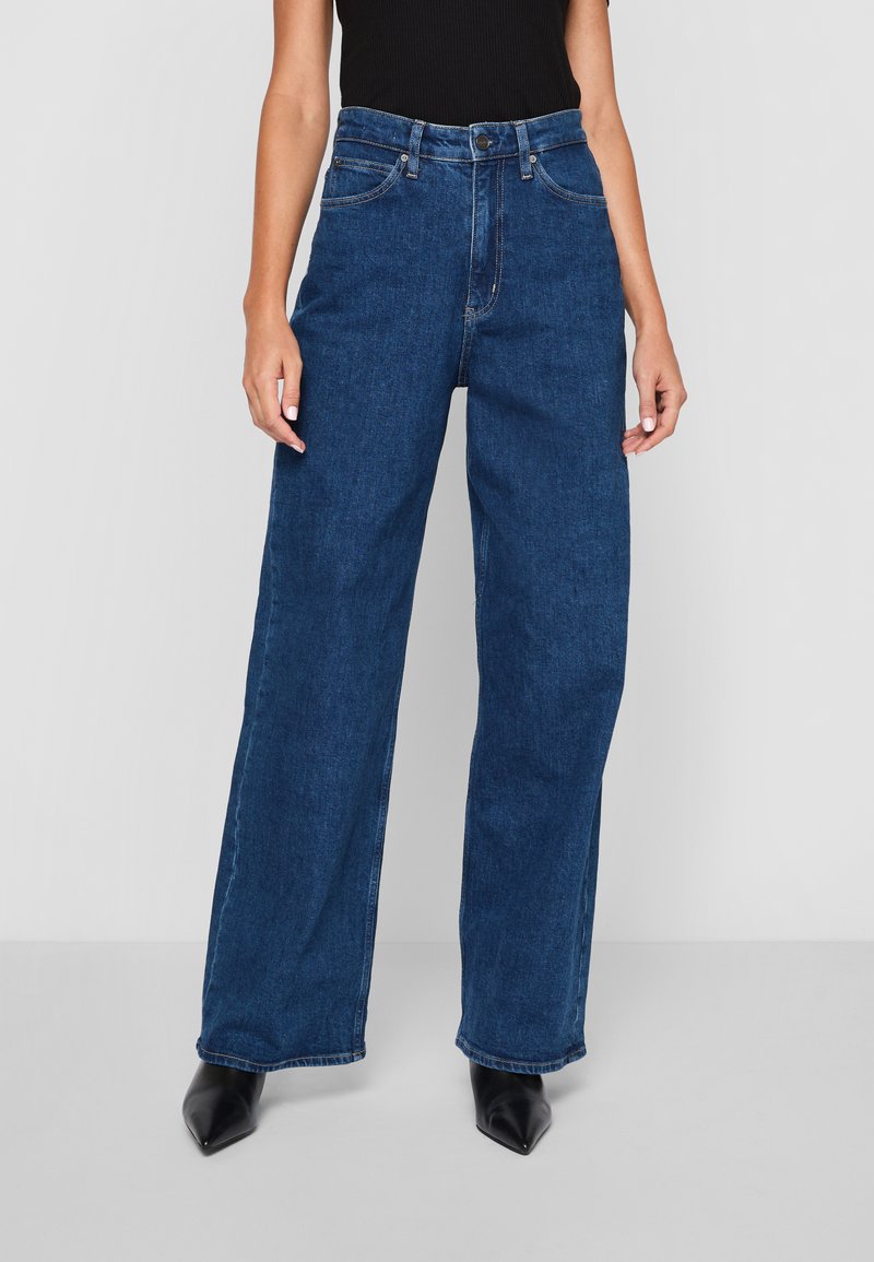 Calvin Klein WIDE STONE - Wide leg - denim dark