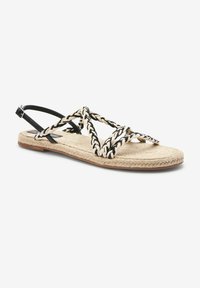 Espadrille sandaal met een jute zool, zwarte gevlochten banden en een verstelbare enkelband. Beschikt over een plat ontwerp en een gestructureerde voetbed.