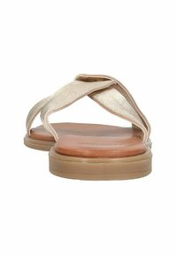 Flat sandals with crossed metallic gold straps, brown footbed, and a light tan rubber sole, featuring a smooth texture.