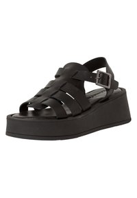 Black platform sandals with multiple woven straps, a buckled ankle strap, and a solid black sole. Matte finish with smooth texture.