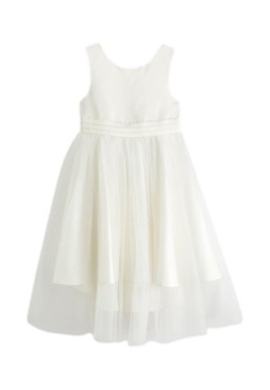 Rochie albă fără mâneci cu corset strâmt, detalii în talie și fustă din tul stratificat care se extinde sub genunchi.