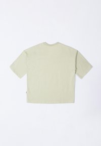 Light green cotton t-shirt, short sleeves, crew neck, boxy fit, plain texture, no graphics, small label on the side seam.