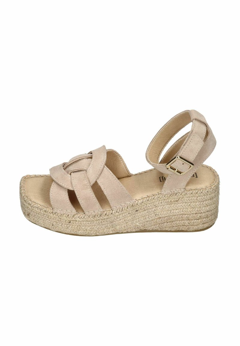 Beige suede wedge sandal with a woven jute platform, featuring a knotted strap design and an adjustable ankle buckle.