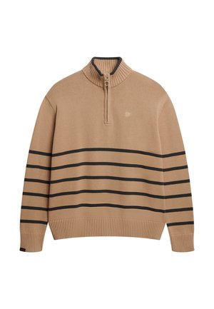 Beige strikket trøje med ribbet krave, lynlås og sorte vandrette striber på kroppen. Har et lille logo på brystet.