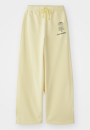 Yellow wide-leg sweatpants with an elastic waistband and drawstring. Features a black floral print and "marimekko" branding on the side.