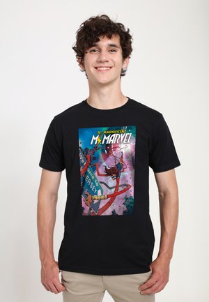 Black short-sleeve t-shirt featuring a vibrant comic-style graphic of Ms. Marvel, with bold colors and details like a sign reading "Welcome to Jersey."